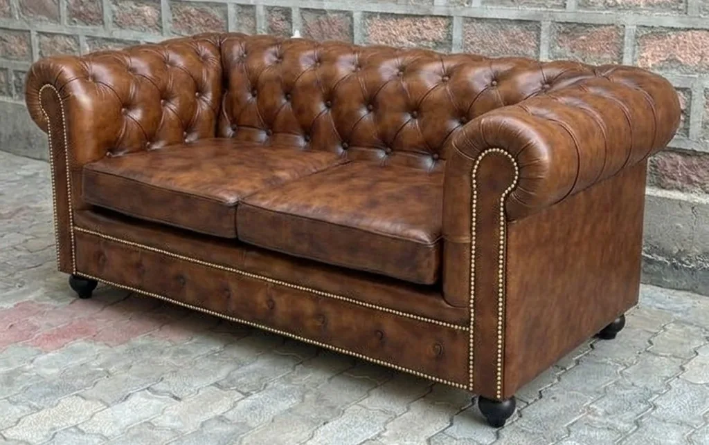 Brown Chesterfield sofa after recolour and conditioning